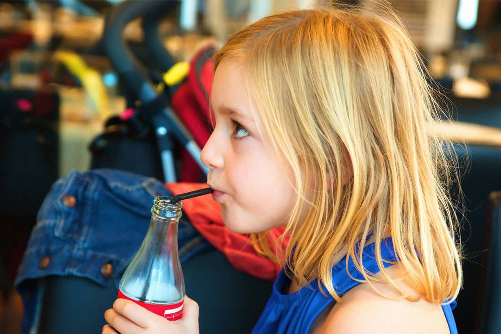 Young girl drinking soft drink | Kids dental health